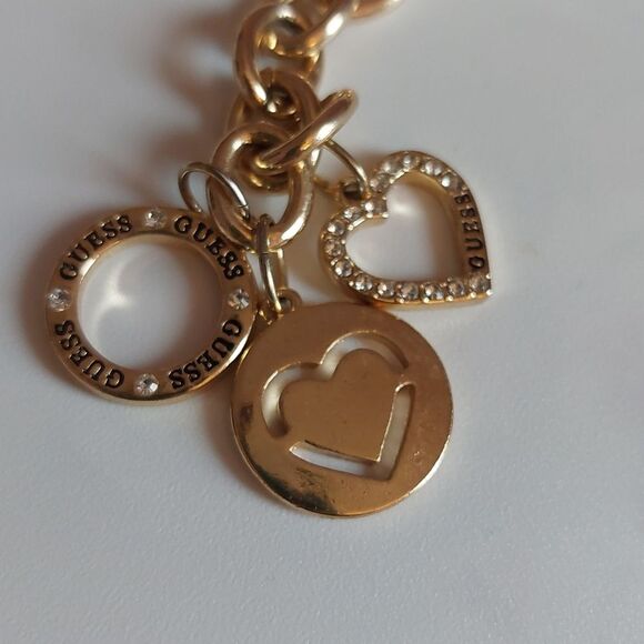 GUESS Gold Tone Heart Paved and  Logo Charms Toggle Clasp Bracelet - Picture 2 of 5